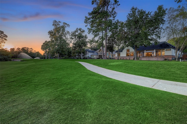 view of home's community with a yard