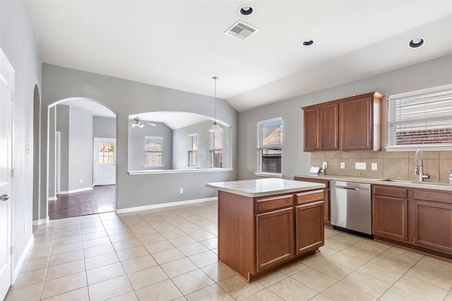 kitchen with dishwasher, a center island, a wealth of natural light, and sink