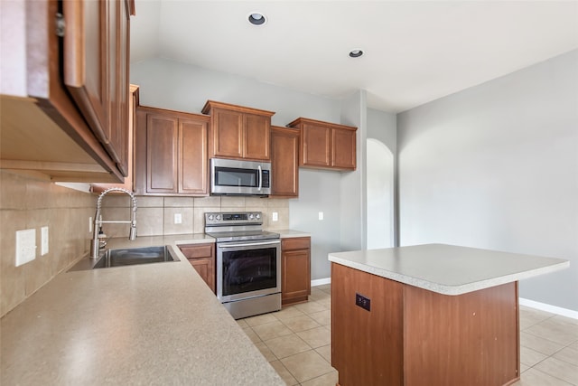 kitchen with decorative backsplash, sink, light tile patterned flooring, and appliances with stainless steel finishes