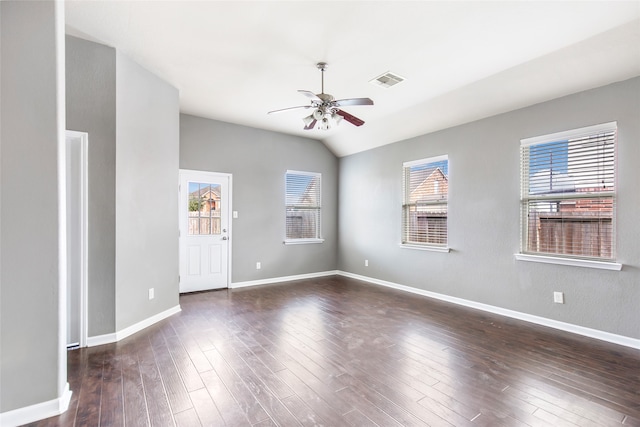 empty room with dark hardwood / wood-style floors, ceiling fan, lofted ceiling, and a wealth of natural light