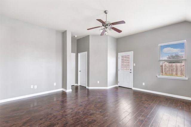 spare room featuring lofted ceiling, ceiling fan, and dark wood-type flooring