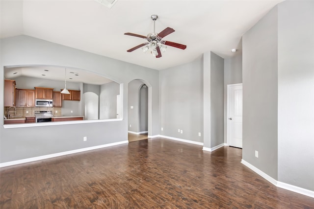 unfurnished living room with ceiling fan, dark hardwood / wood-style flooring, lofted ceiling, and sink