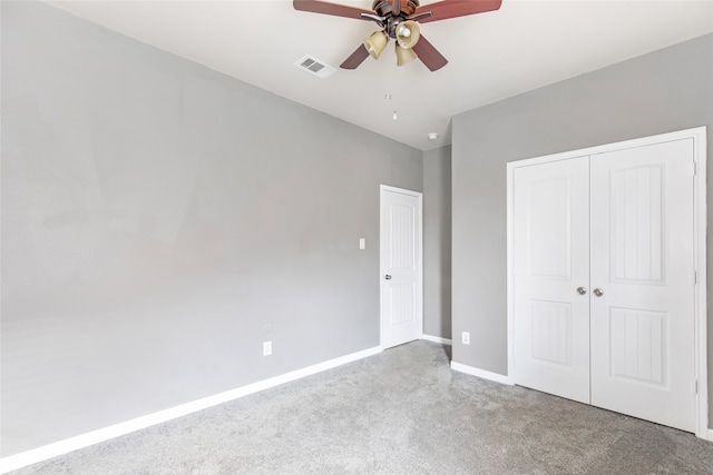 unfurnished bedroom featuring ceiling fan, a closet, and light colored carpet