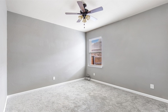 unfurnished room featuring ceiling fan and carpet