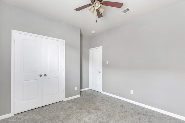 unfurnished bedroom with ceiling fan, a closet, and light carpet