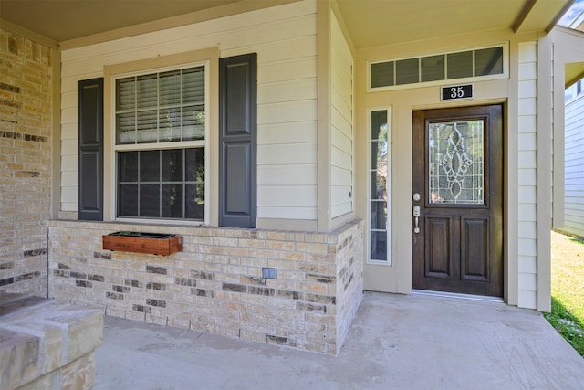 view of exterior entry featuring a porch