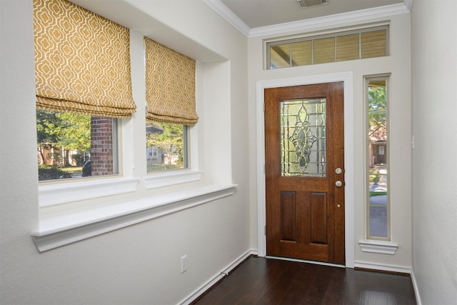 entrance foyer with dark hardwood / wood-style floors and crown molding