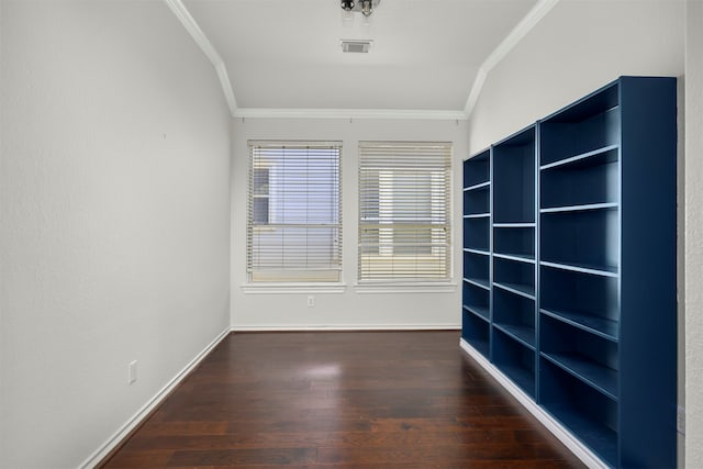 spare room with lofted ceiling, ornamental molding, and dark wood-type flooring