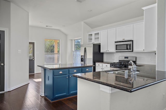 kitchen featuring stainless steel appliances, tasteful backsplash, dark hardwood / wood-style flooring, blue cabinets, and white cabinets