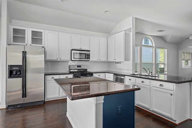 kitchen with white cabinets, sink, a kitchen island, and stainless steel appliances