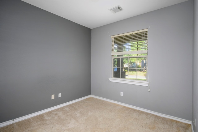 unfurnished room featuring light carpet