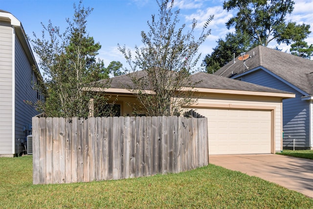 view of front facade with cooling unit, a front yard, and a garage