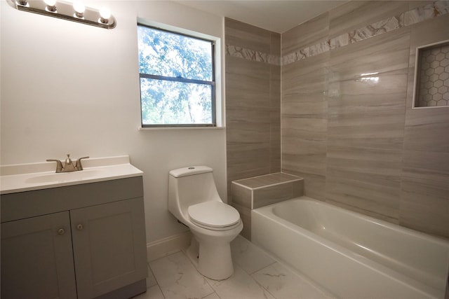 bathroom with a tub, vanity, and toilet