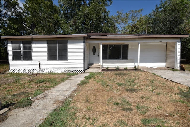 ranch-style home with covered porch and a front lawn