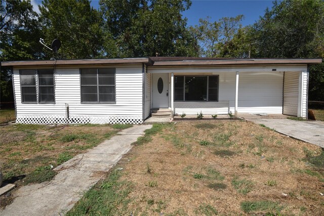314 Reese Rd, Crosby, TX 77532 - view of front of home with a front yard and a carport