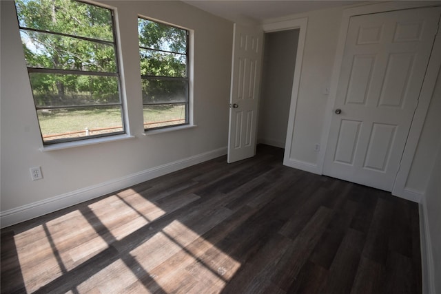 unfurnished bedroom featuring dark wood-type flooring