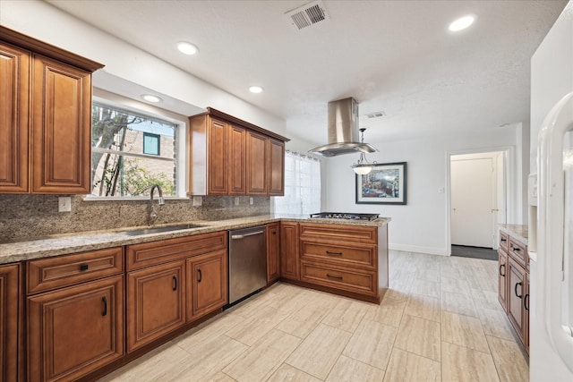 kitchen featuring visible vents, brown cabinetry, island range hood, stainless steel appliances, and a sink