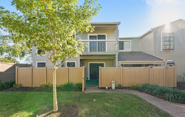 exterior space with a balcony and a lawn