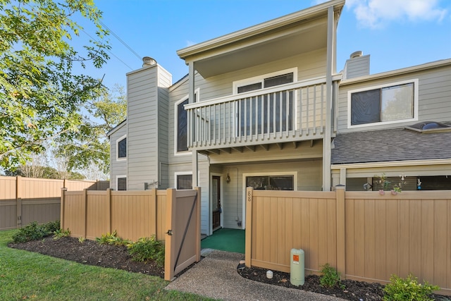 rear view of property with a balcony