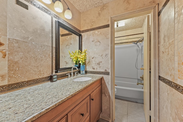 full bathroom with shower / washtub combination, tile patterned flooring, vanity, and a textured ceiling