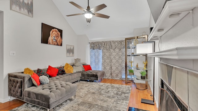 living room featuring a fireplace, hardwood / wood-style flooring, ceiling fan, and lofted ceiling