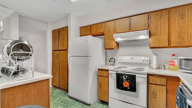 kitchen featuring white appliances and a textured ceiling