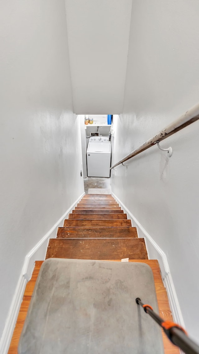 stairway featuring wood-type flooring and washer / clothes dryer