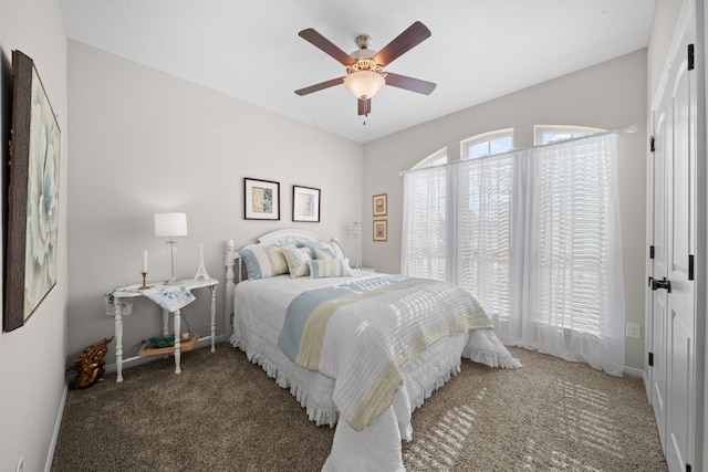 bedroom with dark colored carpet and ceiling fan