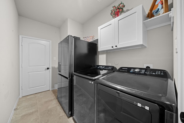 laundry room with cabinets and washer and clothes dryer