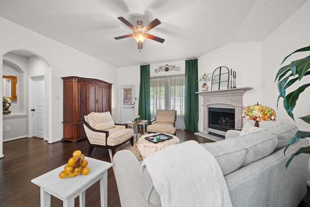 living room featuring ceiling fan and dark hardwood / wood-style flooring