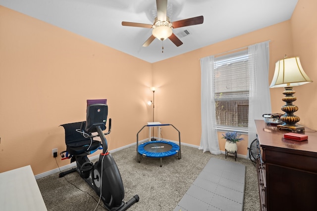 exercise area with ceiling fan and carpet floors