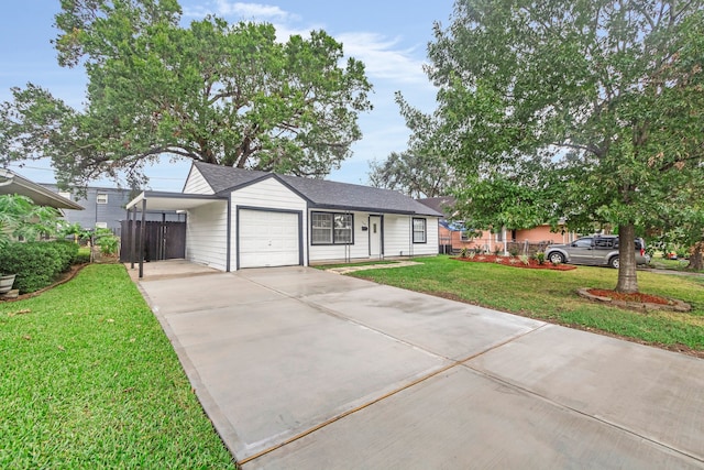 ranch-style home featuring a front yard, a garage, and a carport