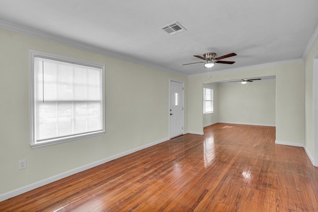 empty room featuring wood-type flooring, ceiling fan, and ornamental molding