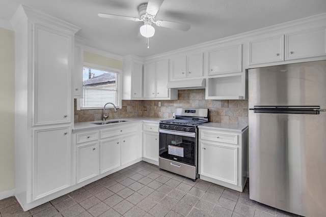 kitchen with sink, white cabinetry, stainless steel appliances, and tasteful backsplash