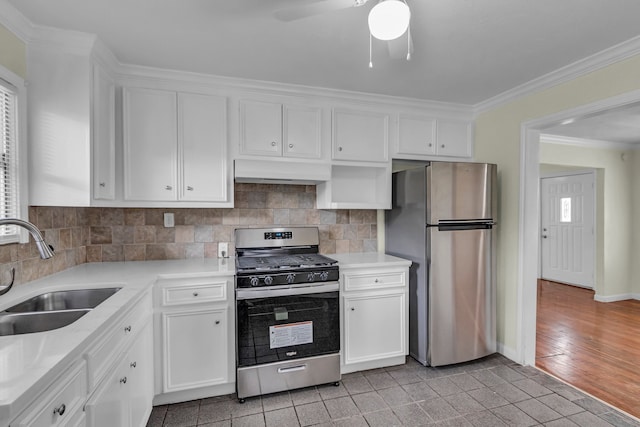 kitchen featuring white cabinetry, sink, stainless steel appliances, extractor fan, and light wood-type flooring