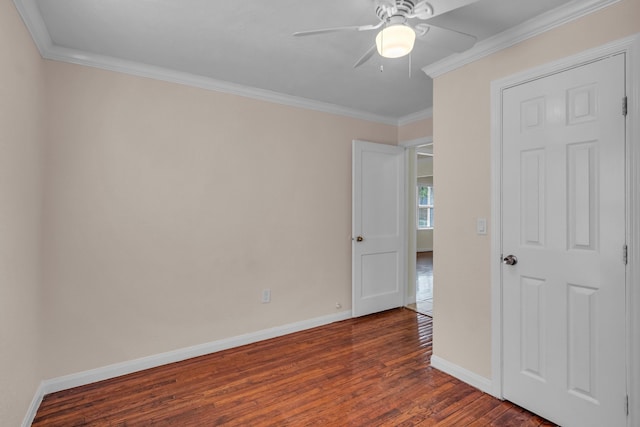 empty room featuring crown molding, dark hardwood / wood-style flooring, and ceiling fan