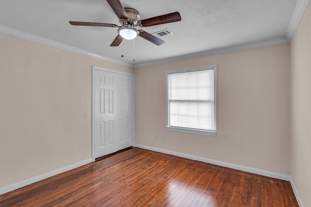 spare room featuring dark hardwood / wood-style flooring, ceiling fan, and ornamental molding