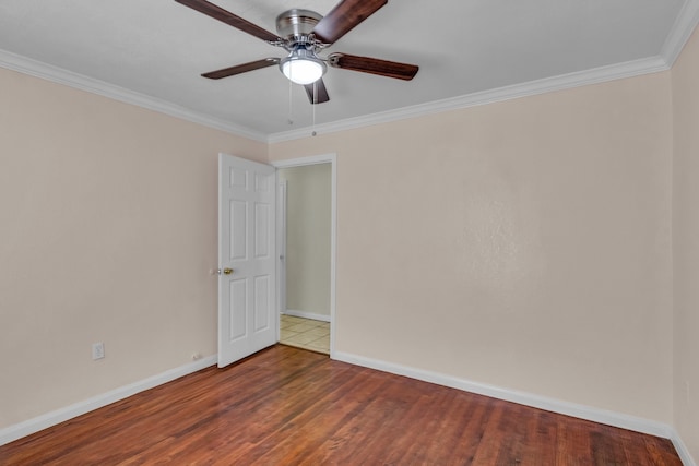 empty room featuring hardwood / wood-style flooring, ceiling fan, and ornamental molding