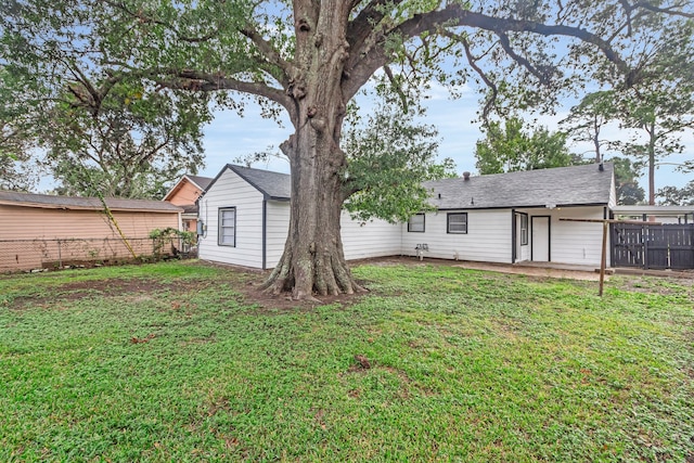 back of property featuring a lawn