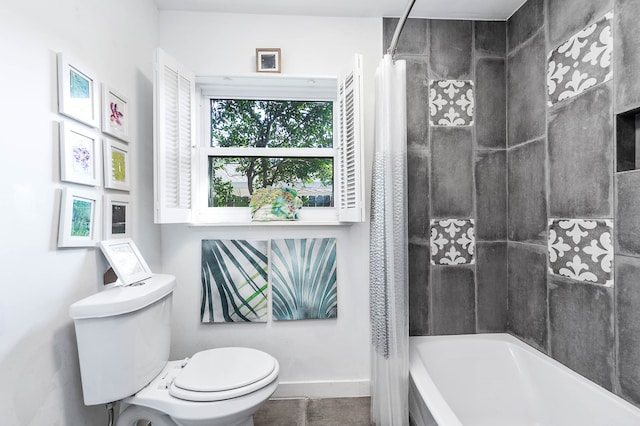 bathroom featuring toilet and shower / bath combo with shower curtain