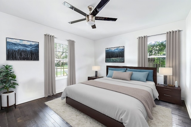 bedroom with dark hardwood / wood-style floors, multiple windows, and ceiling fan