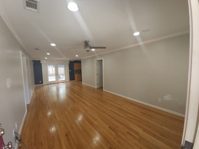 unfurnished living room featuring ceiling fan, french doors, ornamental molding, and light wood-type flooring