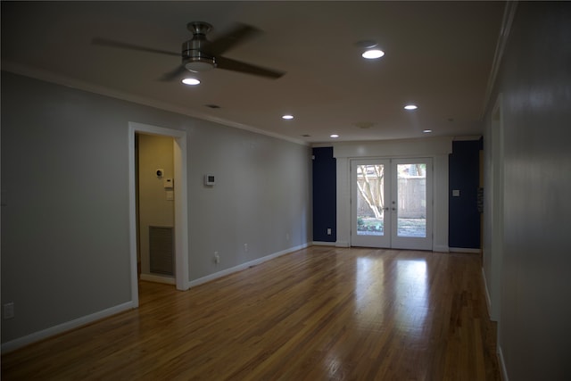 empty room featuring french doors, ceiling fan, crown molding, and hardwood / wood-style floors