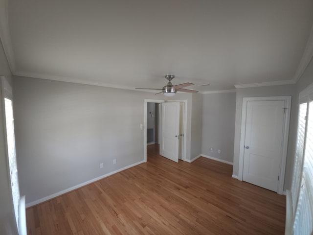 unfurnished bedroom with ceiling fan, ornamental molding, and light hardwood / wood-style flooring