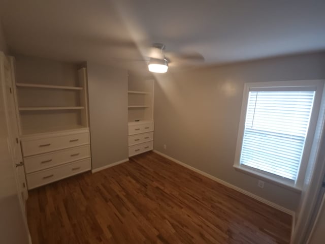 unfurnished bedroom featuring dark hardwood / wood-style flooring and ceiling fan