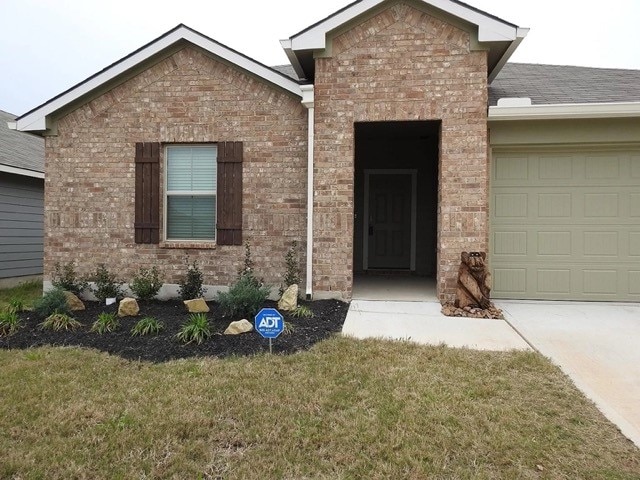 view of front of home featuring a garage and a front lawn