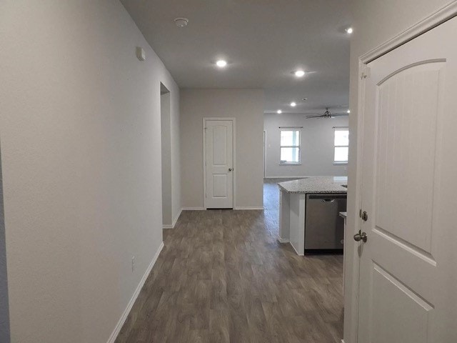 corridor with dark hardwood / wood-style flooring