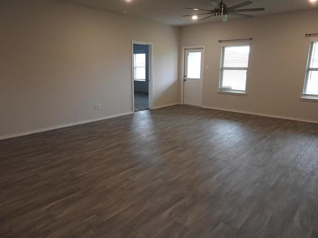 empty room featuring ceiling fan and dark hardwood / wood-style floors