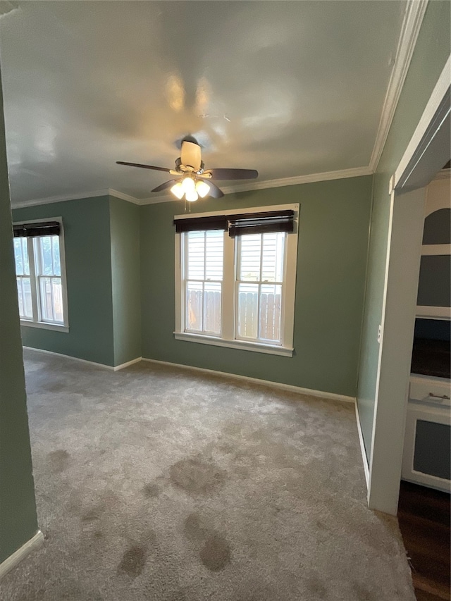 unfurnished room with light carpet, ceiling fan, and ornamental molding