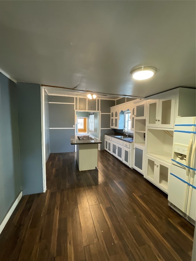 kitchen featuring sink, white cabinets, a center island, dark hardwood / wood-style floors, and white fridge with ice dispenser